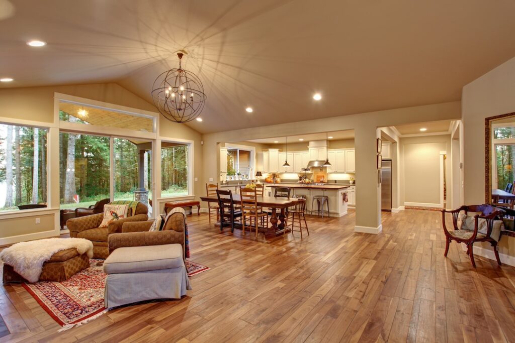 Well lit dinning room with connected living room with lots of decor.